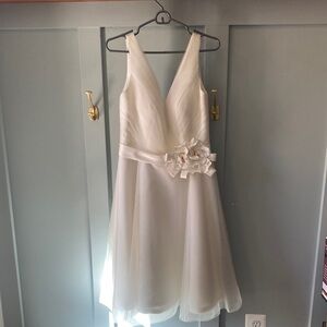 Elegant White Sleeveless Dress with Floral Accent